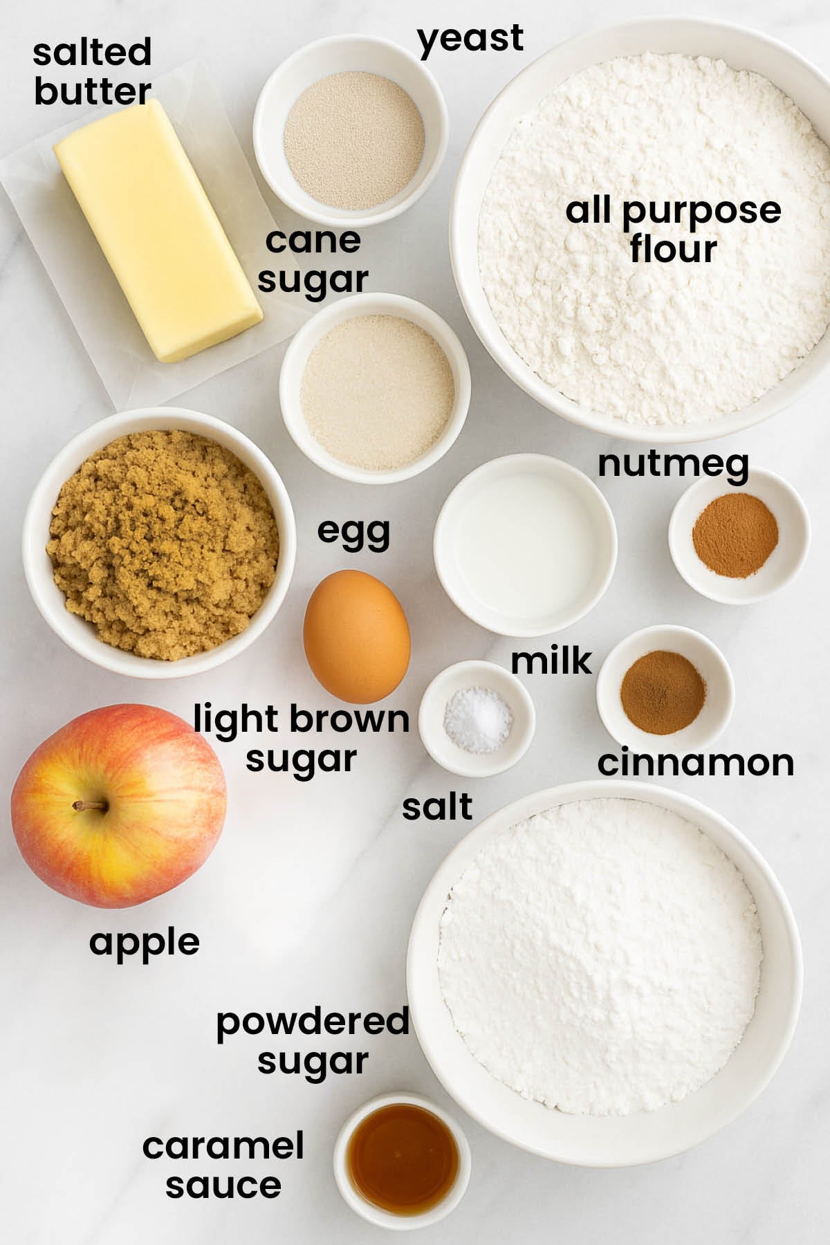 individual ingredients for apple pie cinnamon rolls laid out against a white background.