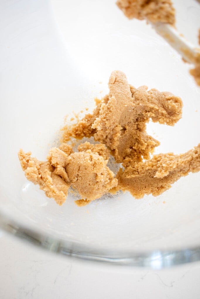 butter and light brown sugar creamed together in a glass mixing bowl.