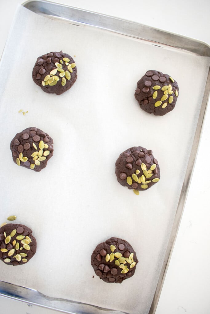 double chocolate pumpkin cookie dough on a baking sheet with parchment paper.