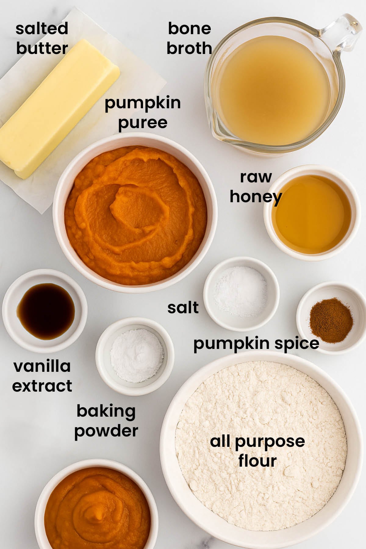 individual ingredients for healthy pumpkin waffles laid out against a white background.