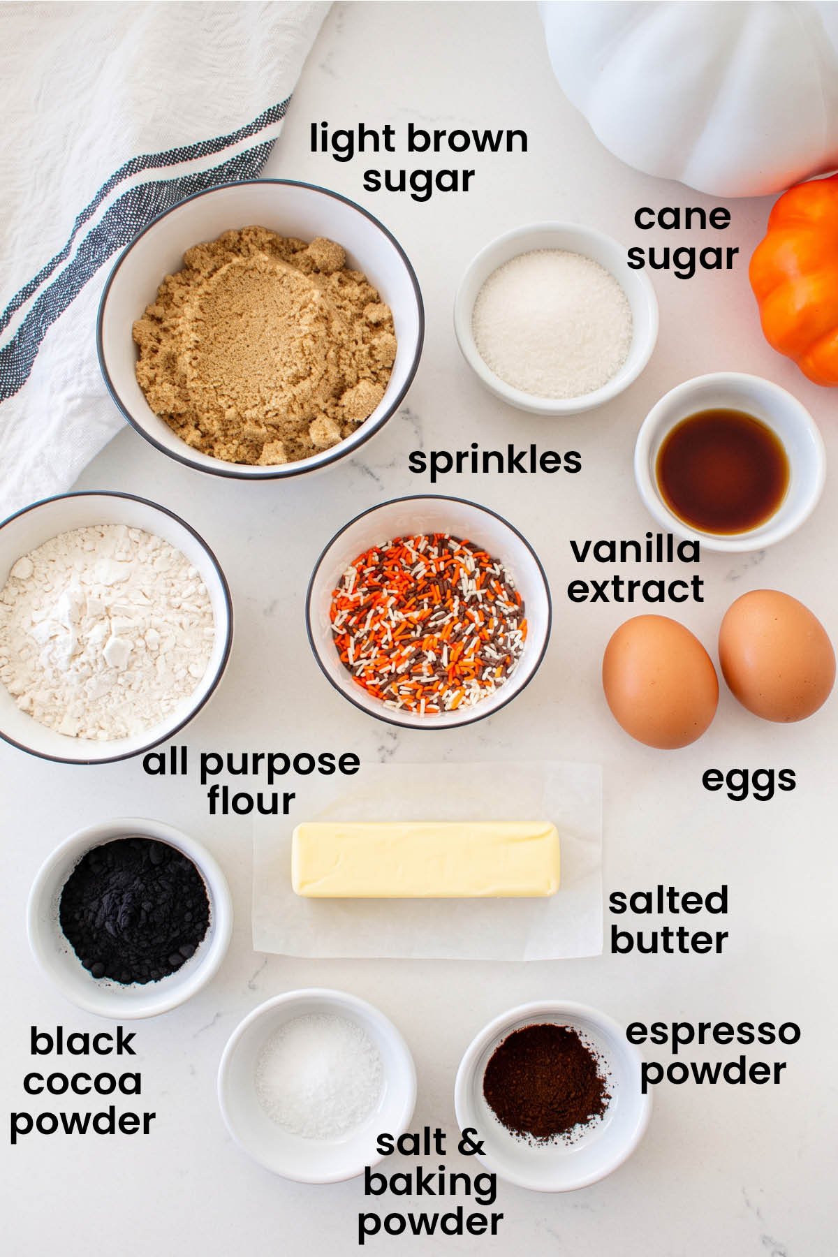 individual ingredients for organic halloween cookies laid out against a white background.