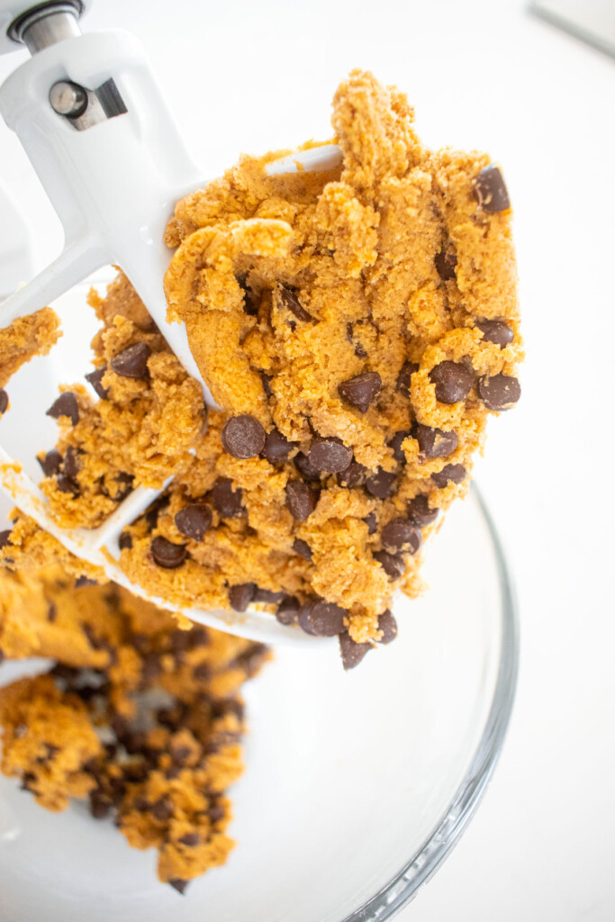 pumpkin chocolate chip cookie dough in a glass mixing bowl.