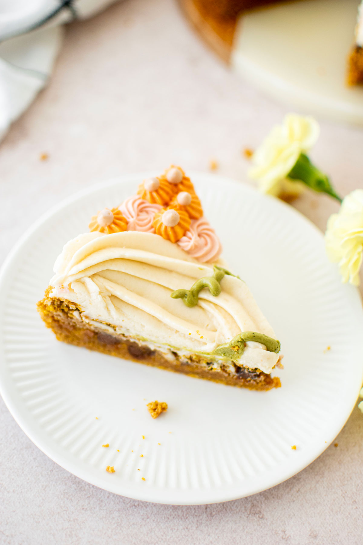 slice of pumpkin chocolate chip cookie cake on a white plate.