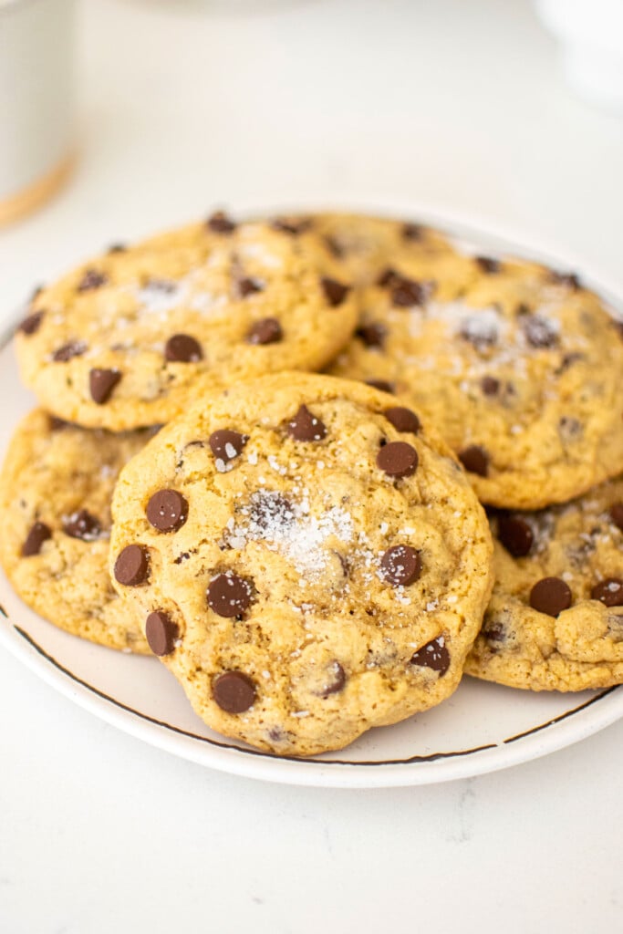 maple brown sugar cookies on a white plate on a white marble counter.