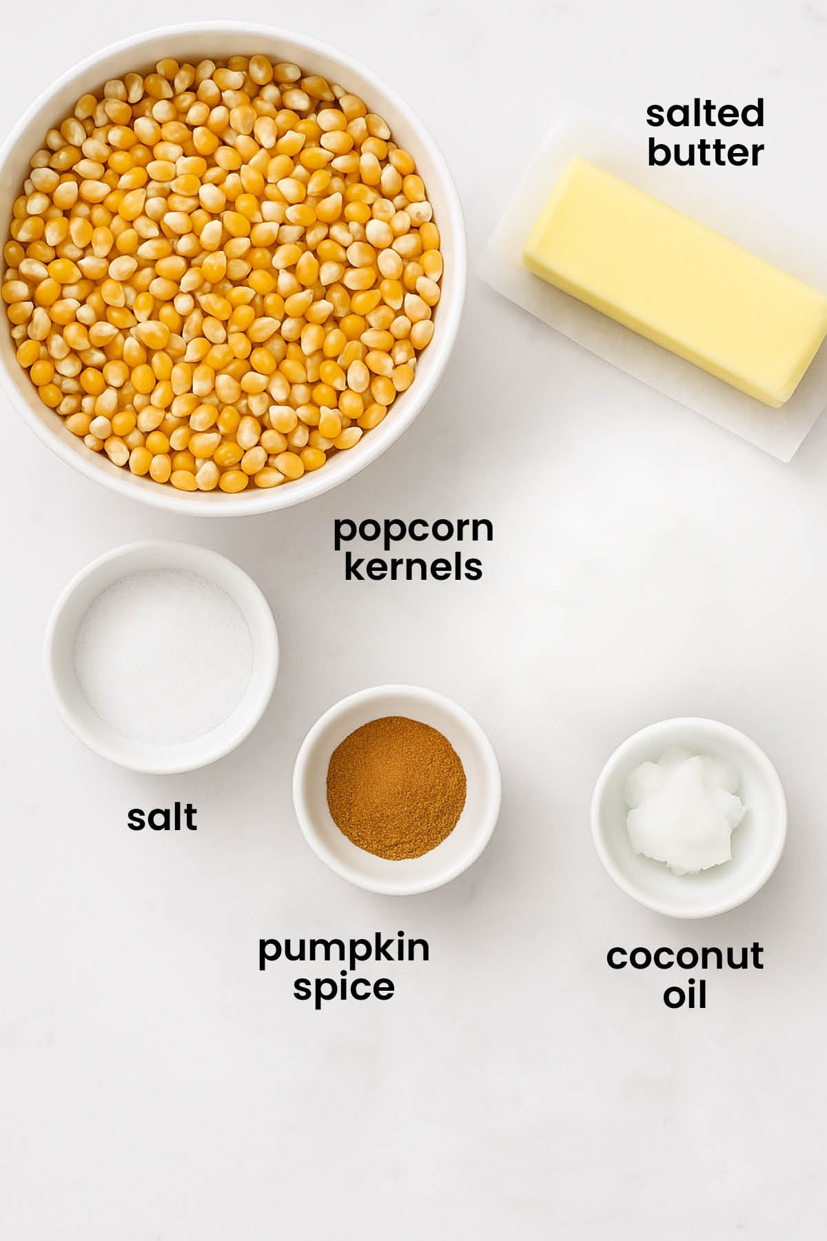 individual ingredients for organic brown butter pumpkin spice popcorn laid out against a white background.
