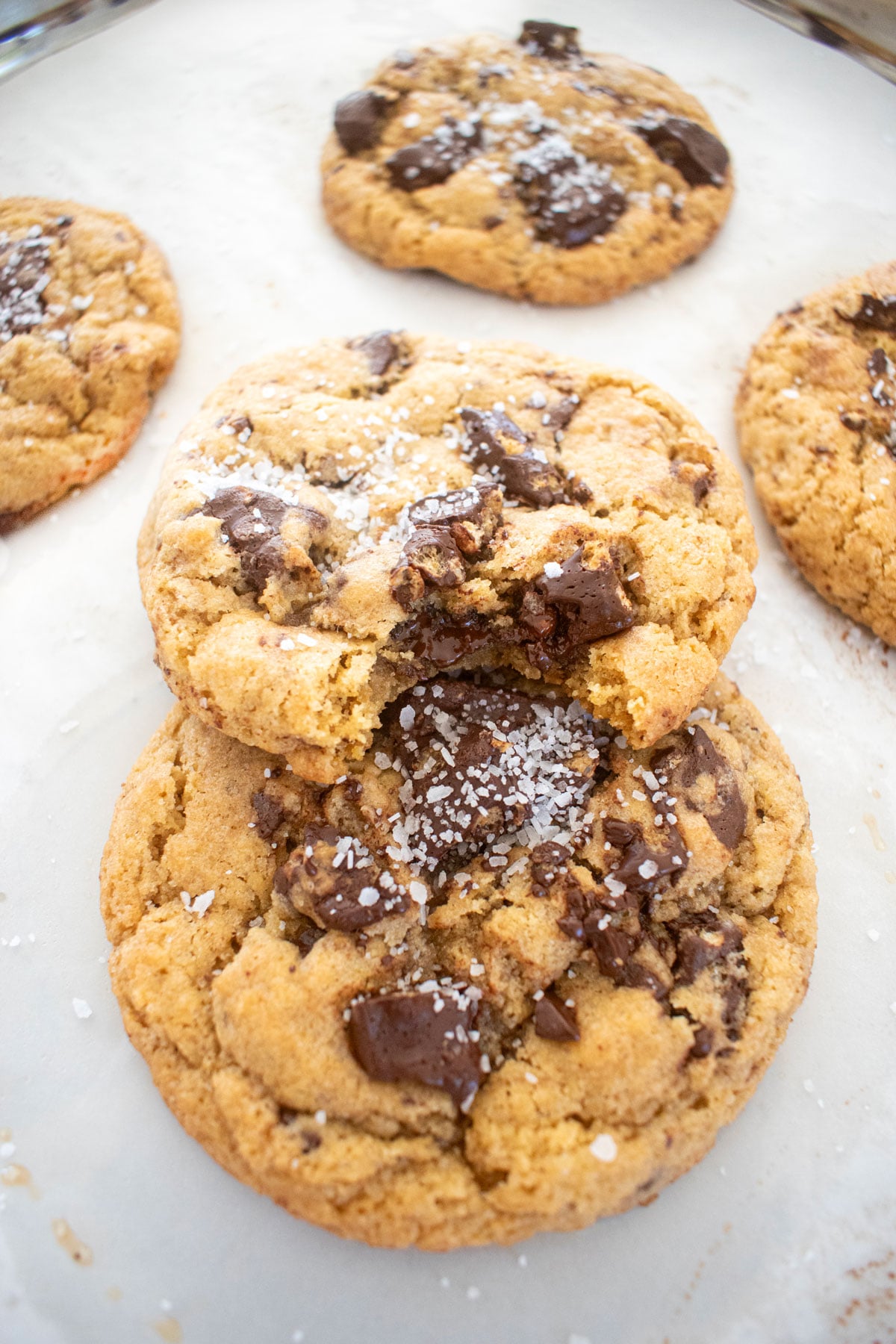 crunch bar cookies on a baking sheet one with a bite taken out of it.