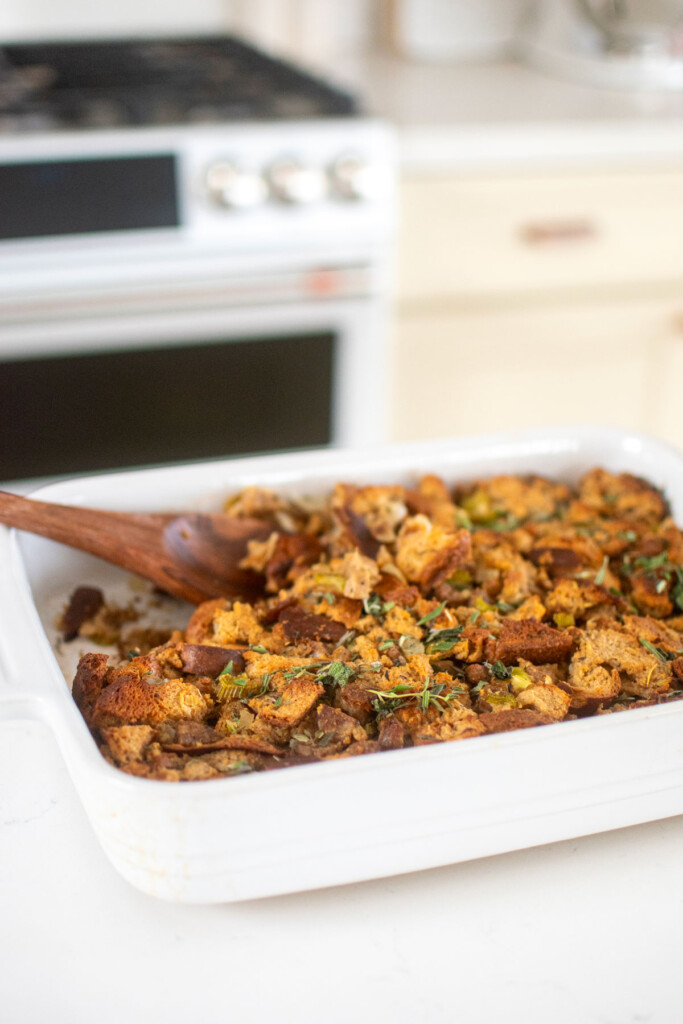 easy stuffing recipe in a white ceramic dish on a marble counter.