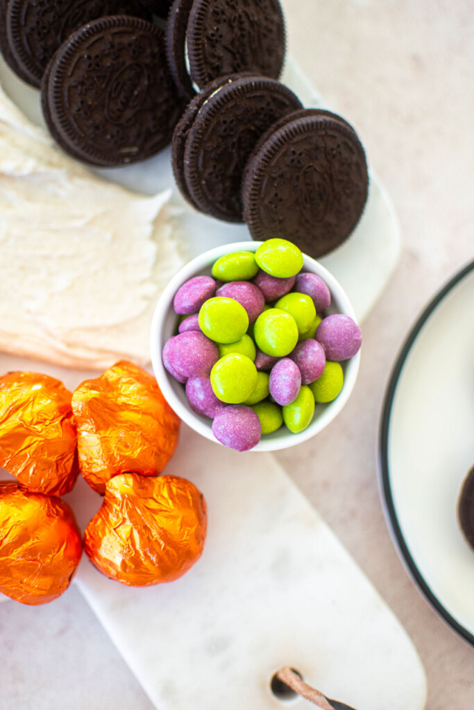 bowl of candy on a halloween dessert board.