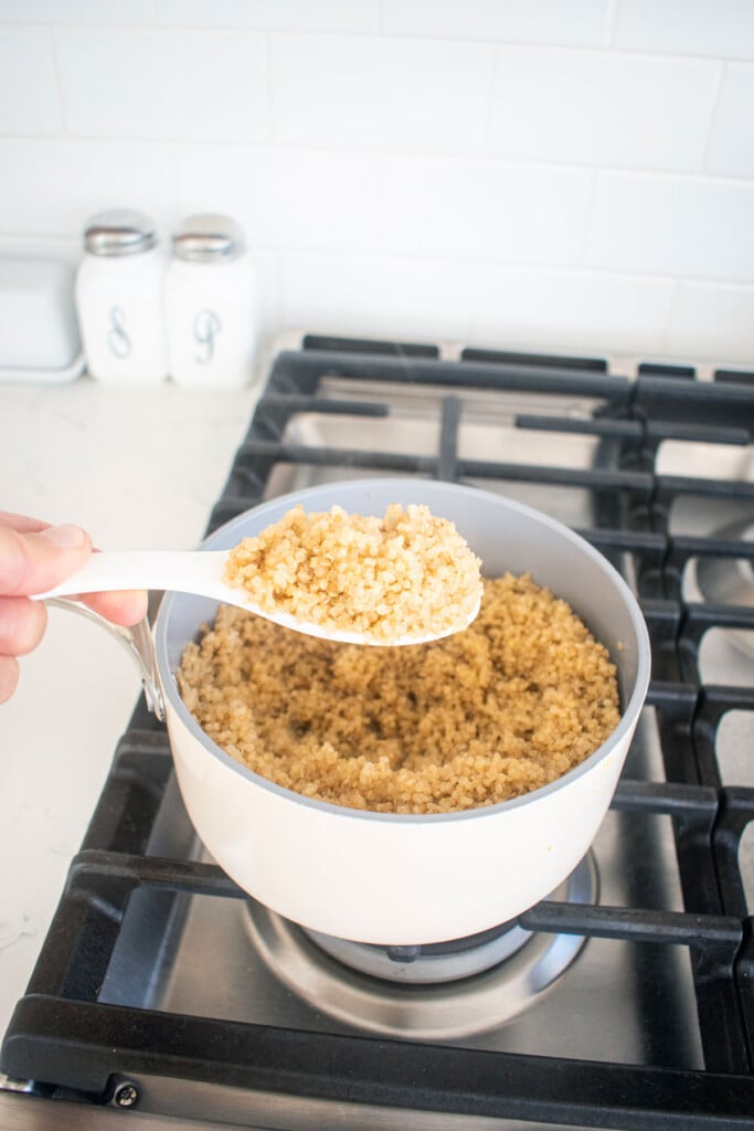 cooked bone broth quinoa in a small pot over the stovetop.