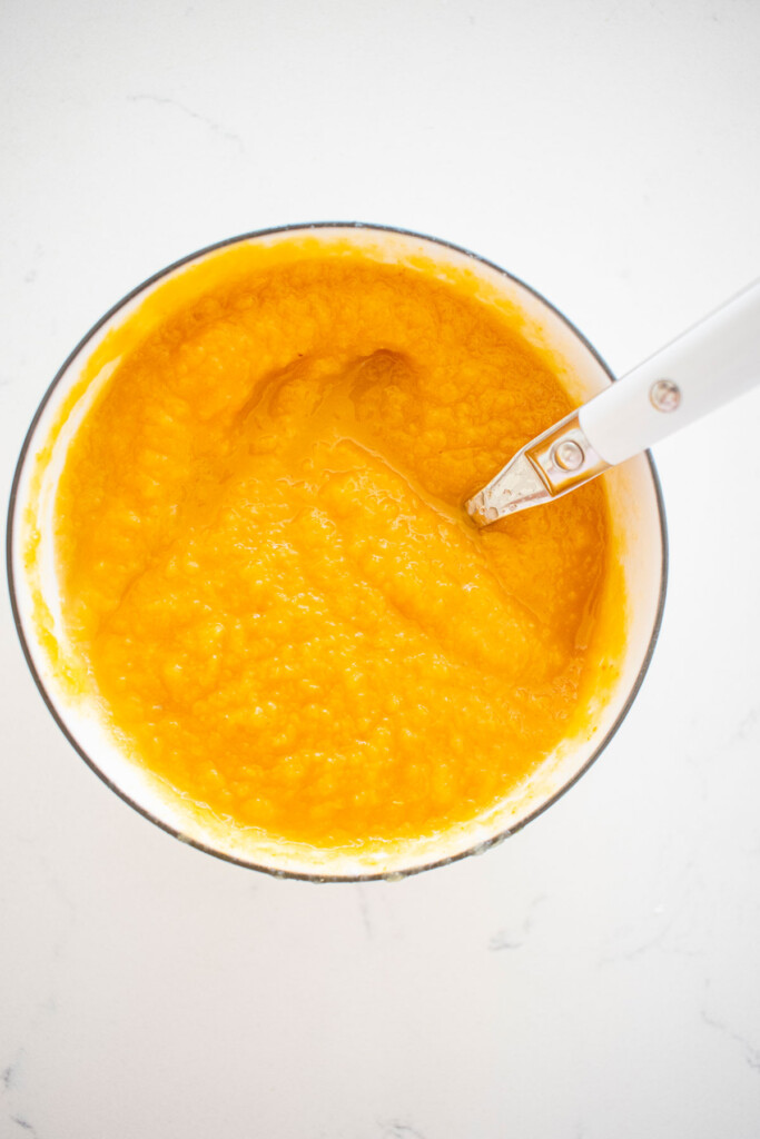 pumpkin puree, applesauce and apple cider vinegar in a white bowl on a marble counter.