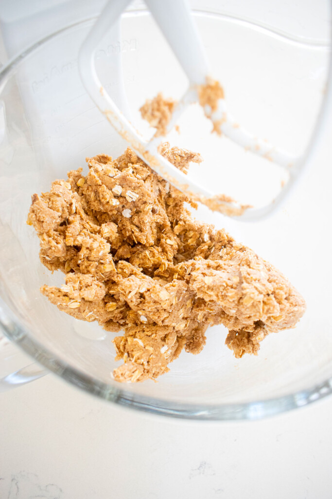 vegan spiced oatmeal cookie dough in a glass mixing bowl.