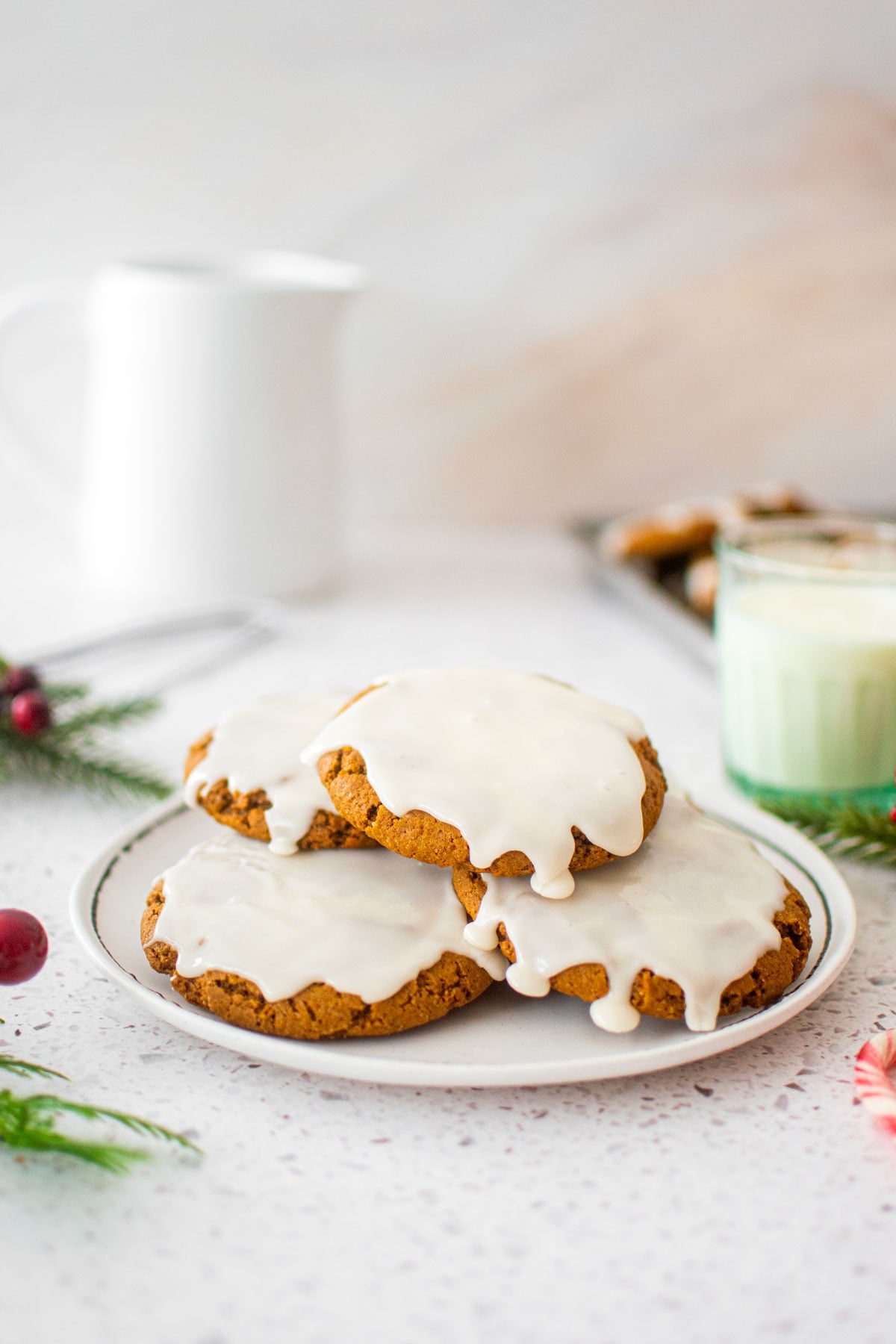 plate of eggless pumpkin gingerbread cookies on a white marble counter.