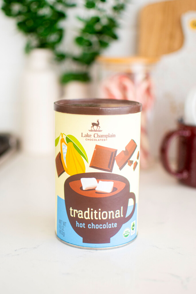 lake champlain hot chocolate mix container on a white marble counter.