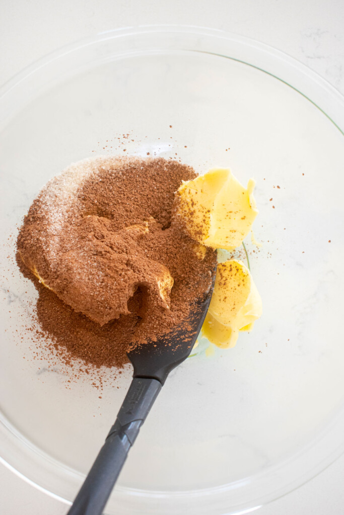 butter, hot chocolate mix and sugar in a glass mixing bowl.