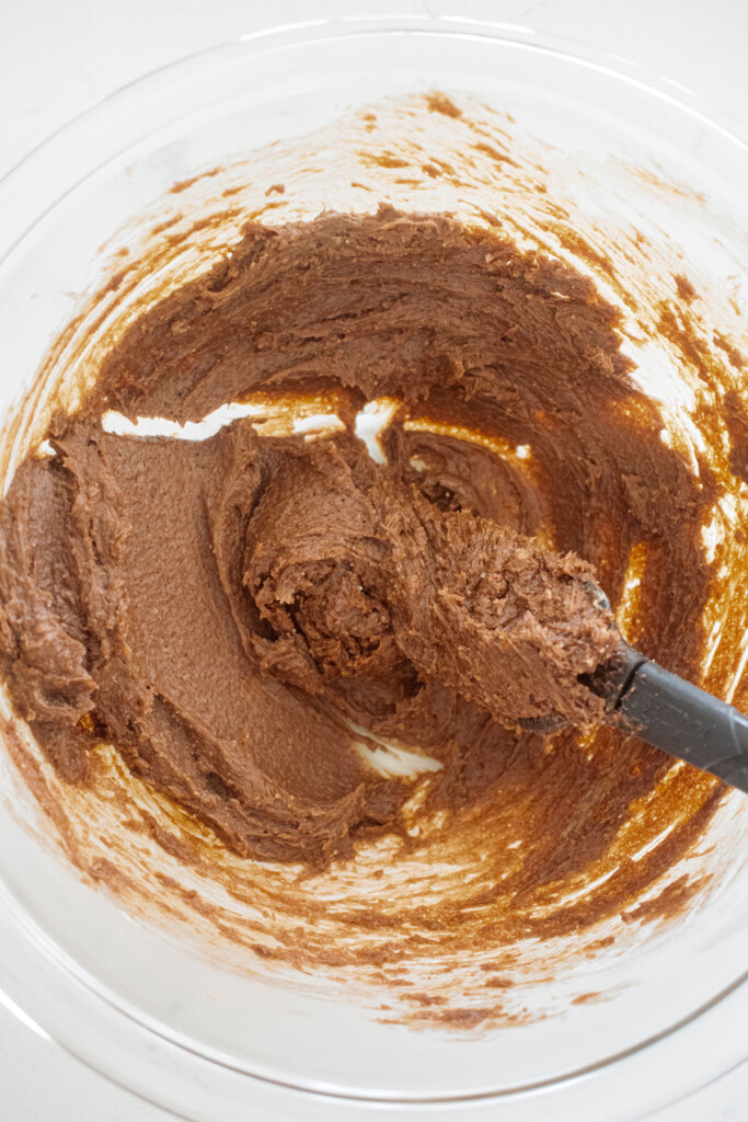 hot chocolate mix, butter and sugar mixed together in a glass mixing bowl.