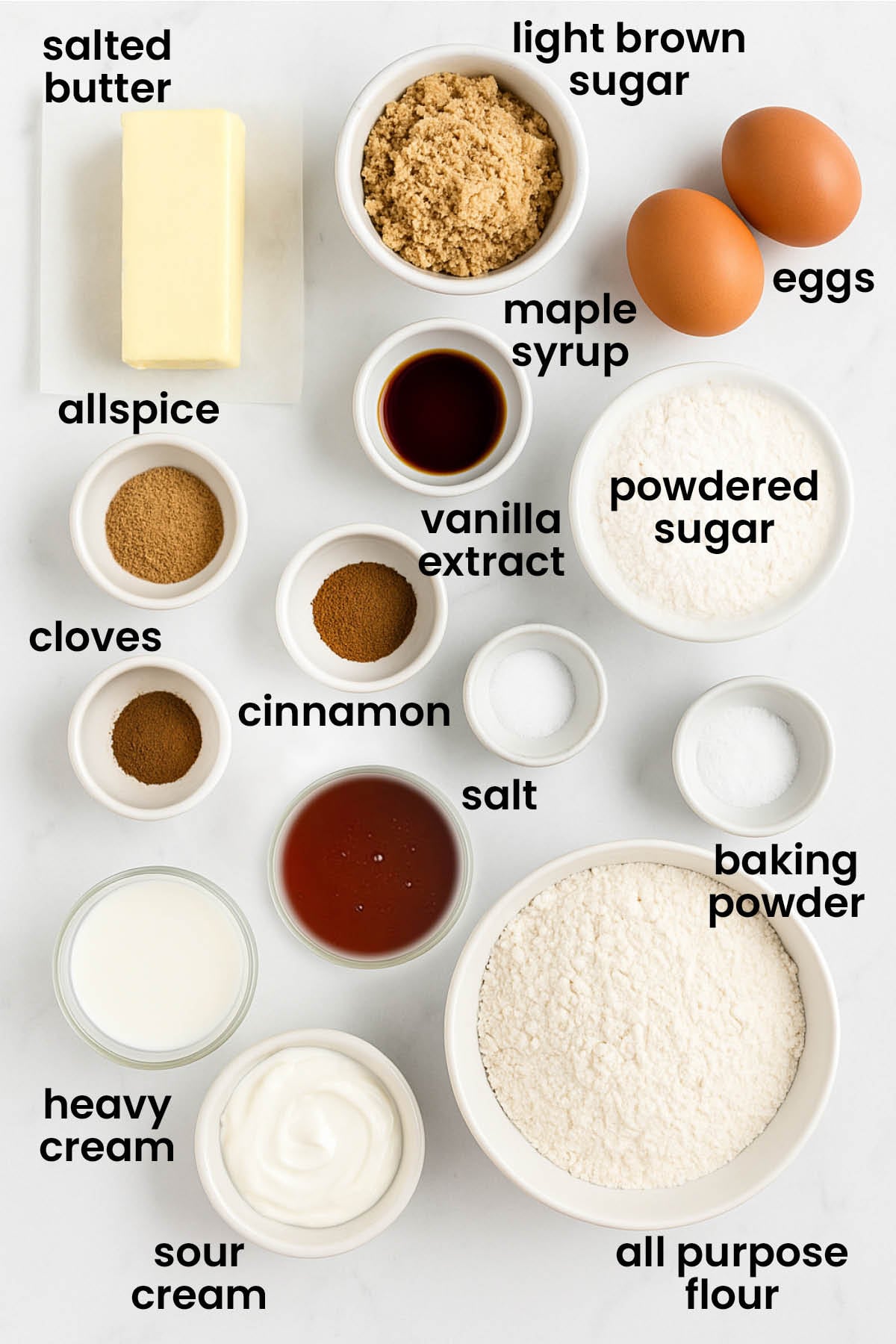 individual ingredients for maple spice cake with brown sugar frosting laid out against a white background.