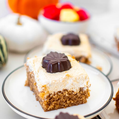 slice of maple spice cake on a plate on a white marble counter.