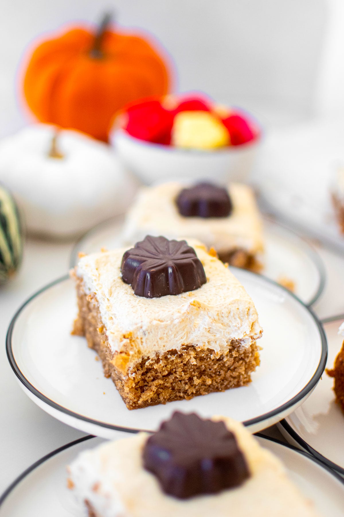slice of maple spice cake on a plate on a white marble counter.