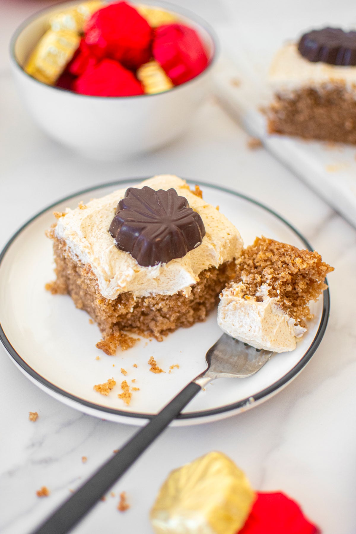 slice of maple spice cake on a plate on a white marble counter.