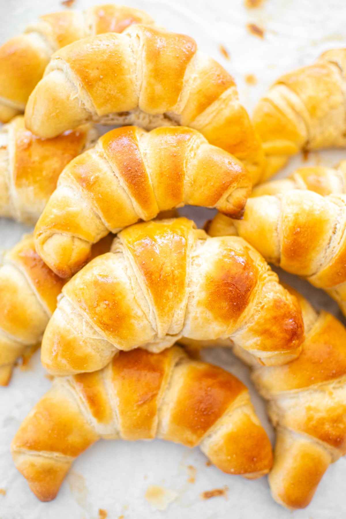 sourdough crescent rolls on a baking sheet.