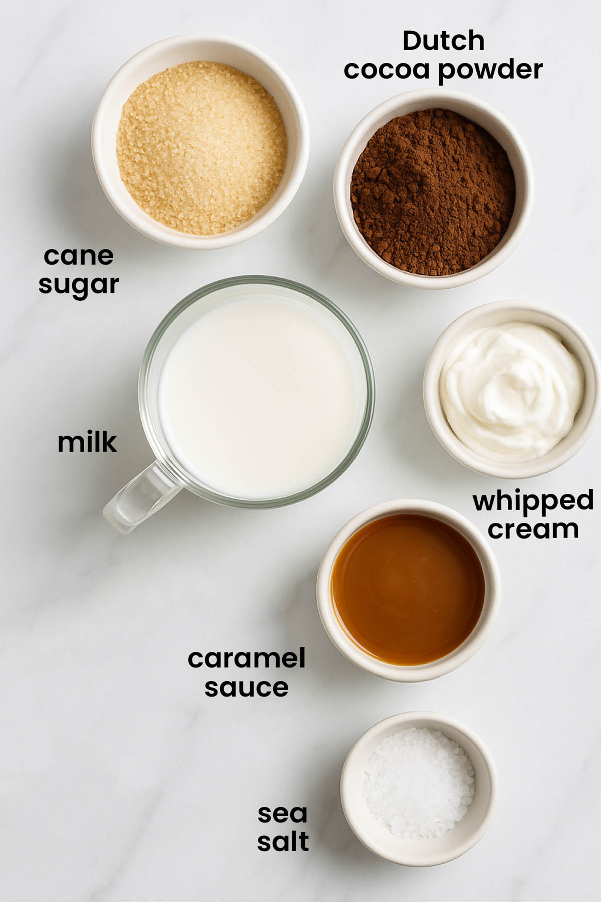 individual ingredients for caramel hot cocoa laid out against a white background.