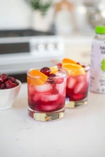 cranberry mocktail with coconut water on a white kitchen counter.