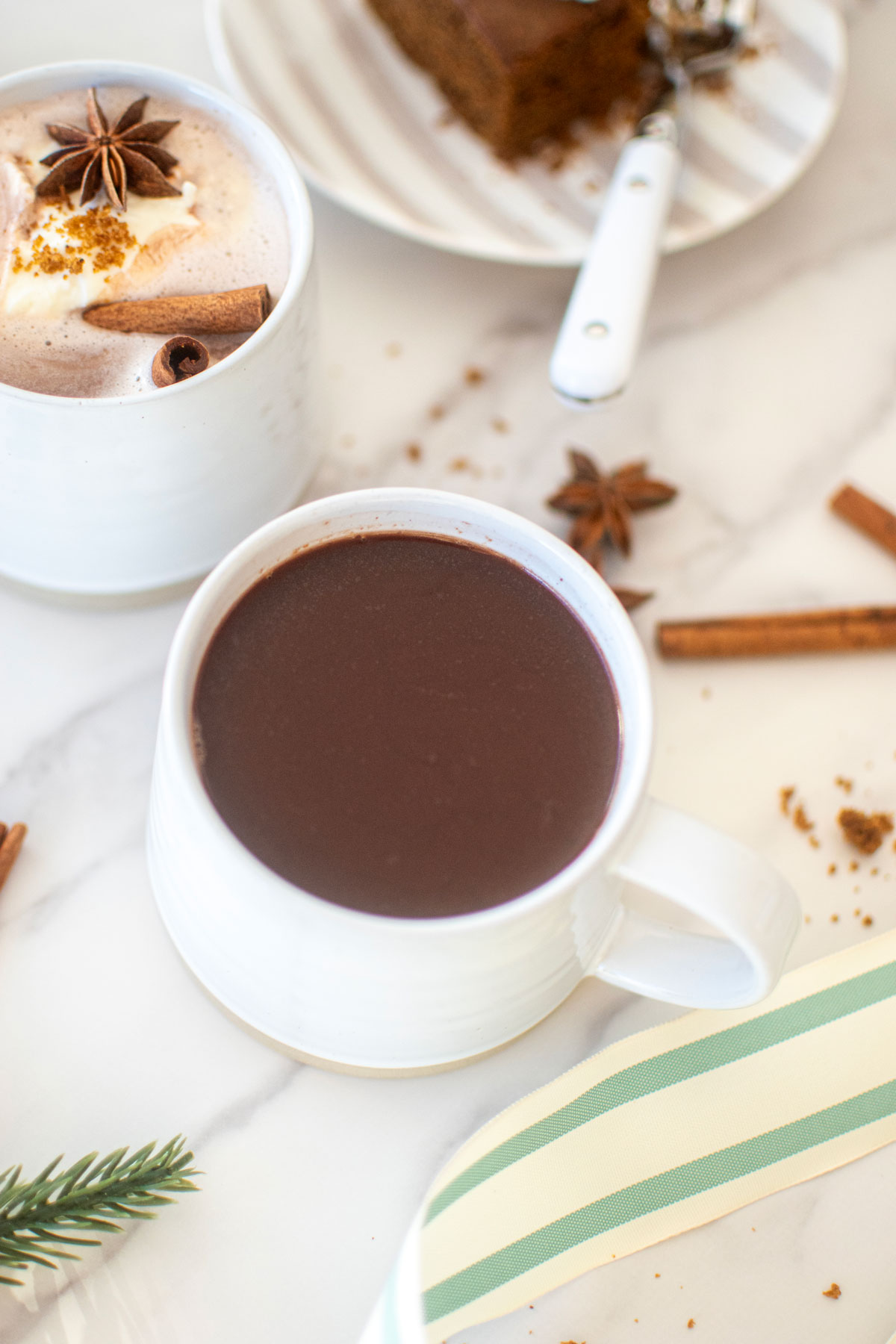 healthy gingerbread hot cocoa with bone broth on a white marble countertop.