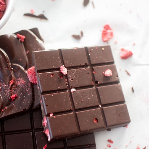 strawberry chocolate bars on a white marble countertop.