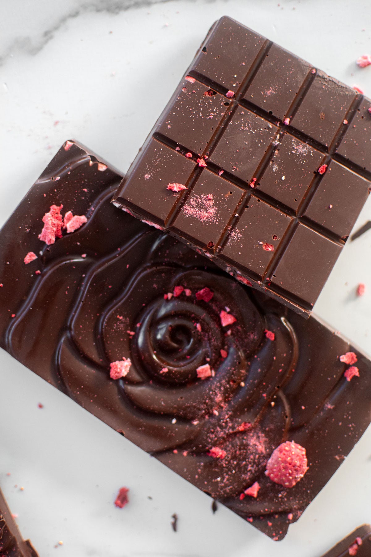 strawberry chocolate bars on a white marble countertop.