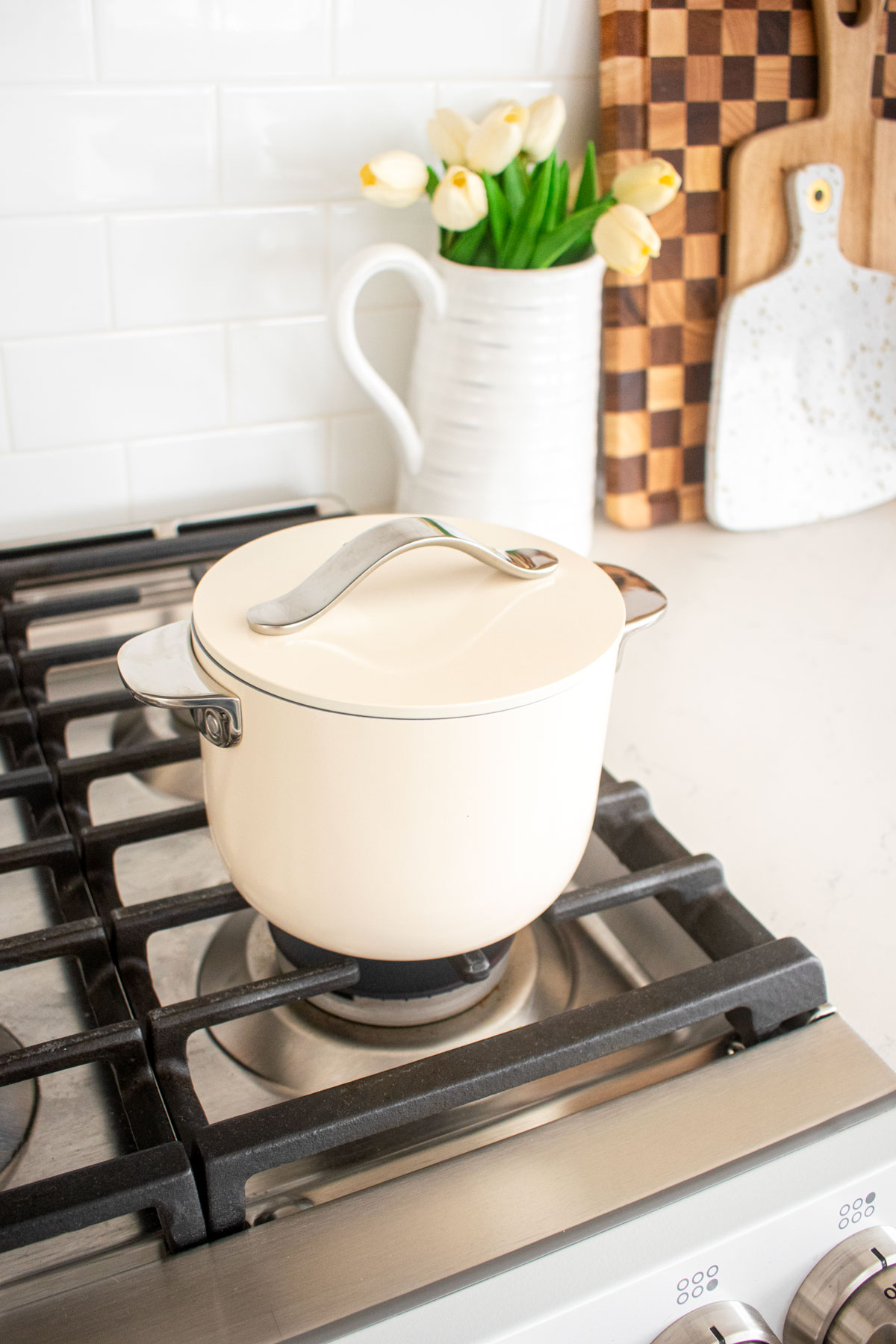 caraway petite cooker in cream on a stovetop.