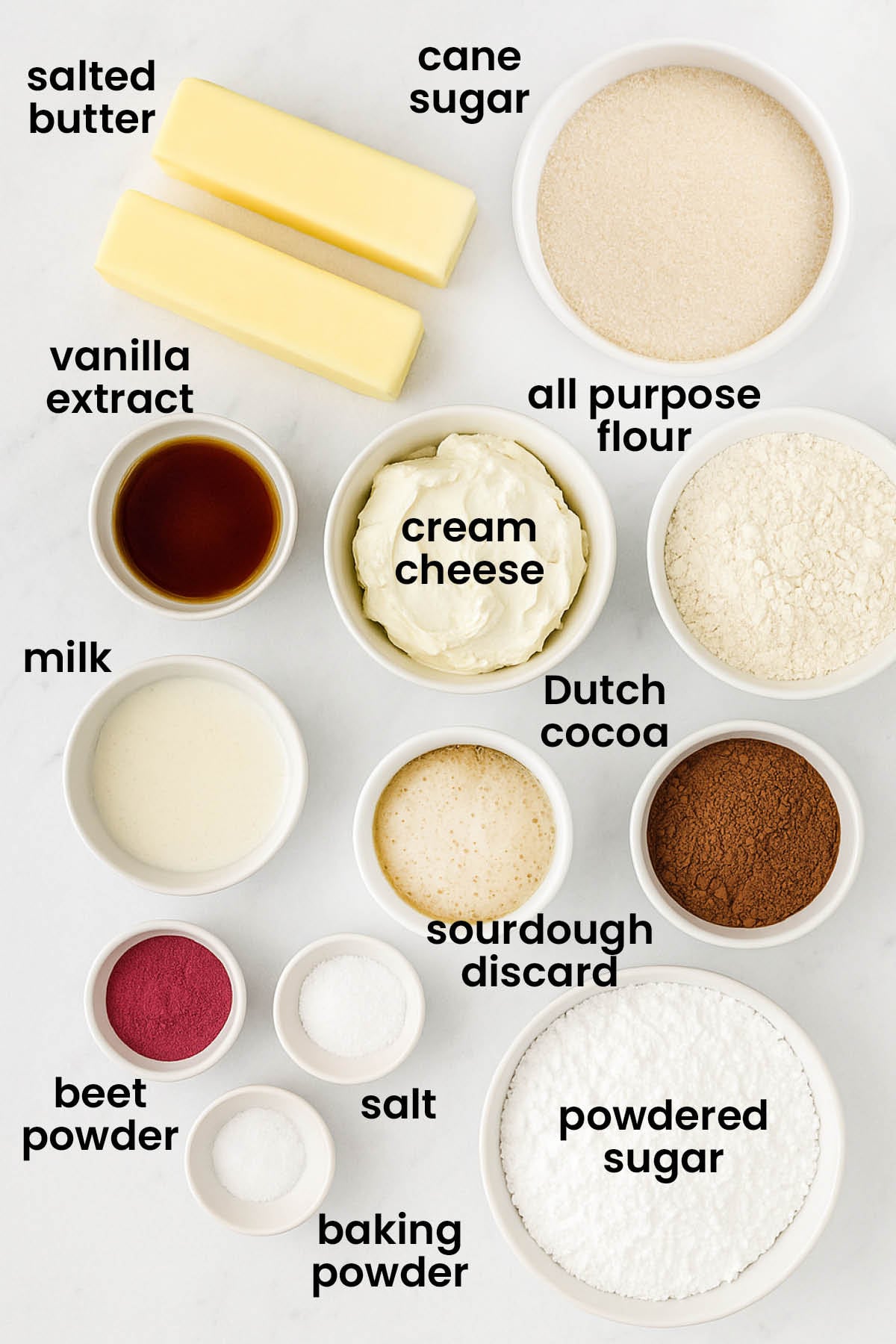 individual ingredients for sourdough red velvet cookies laid out against a white background.