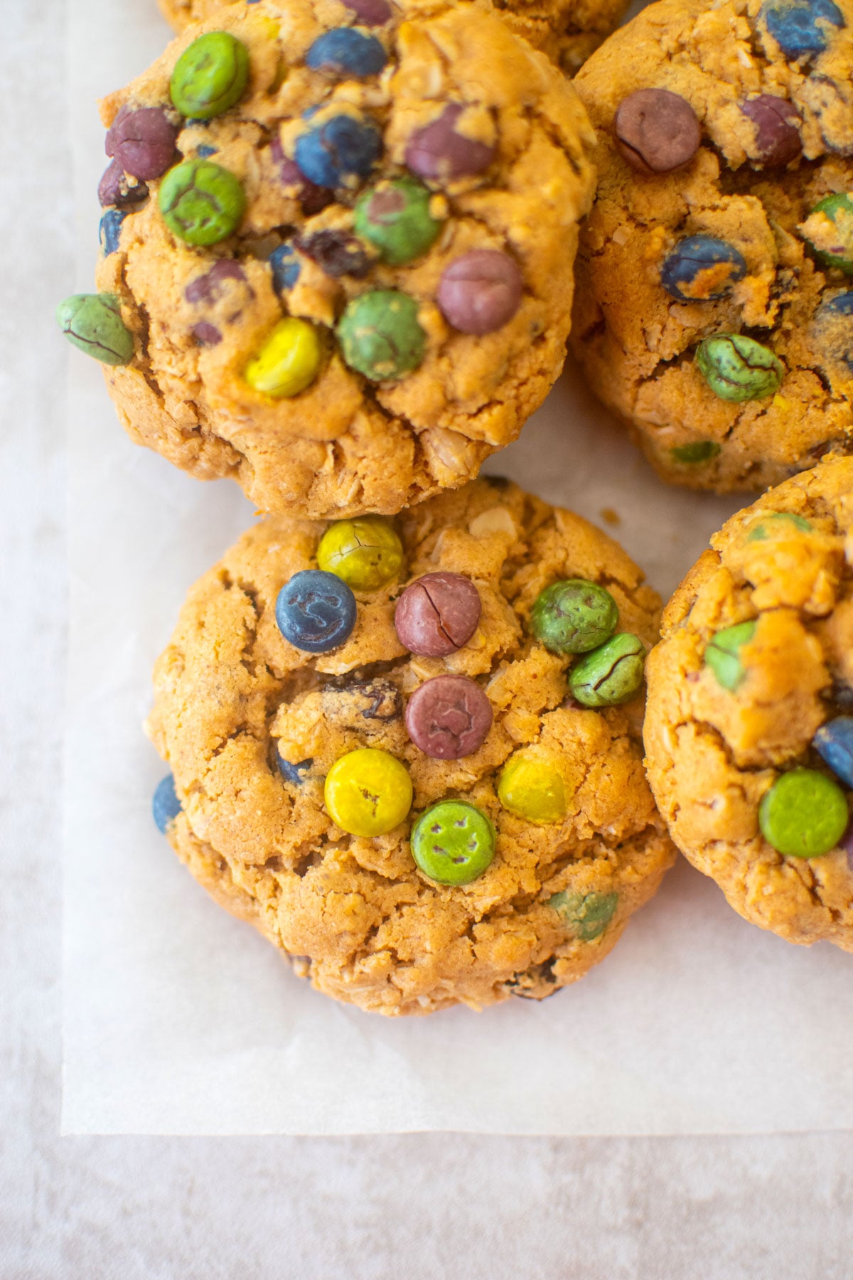 eggless monster cookies on a piece of parchment paper.