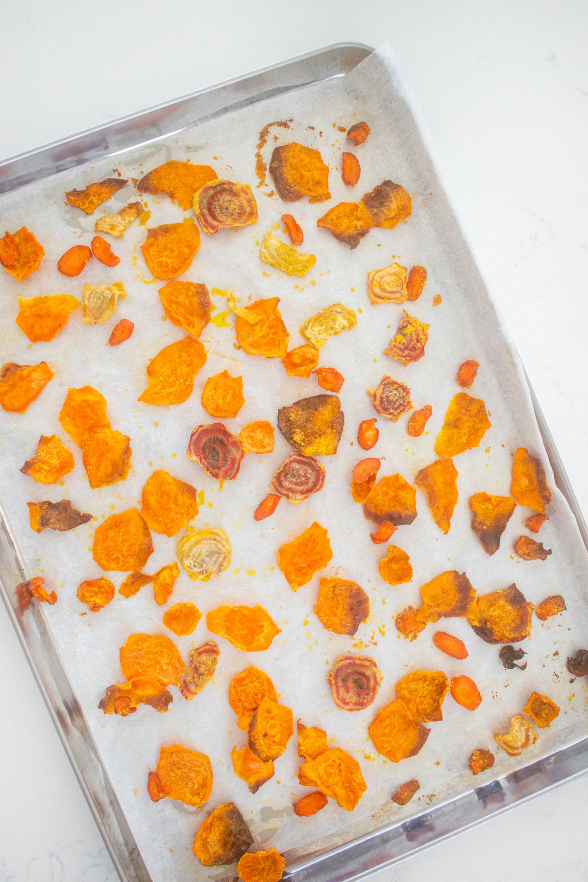 veggie treats for dogs on a baking sheet on a white countertop.