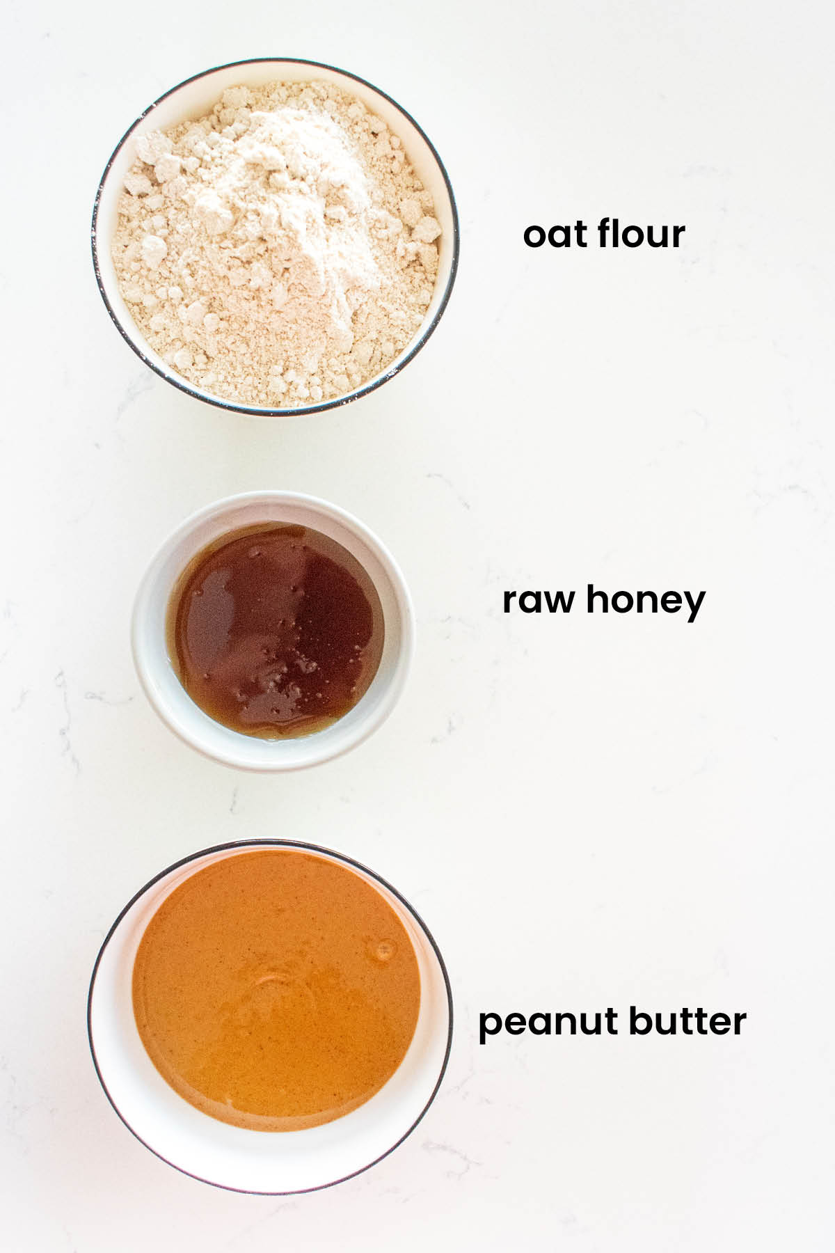 individual ingredients for mini peanut butter oat dog treats laid out against a white background.