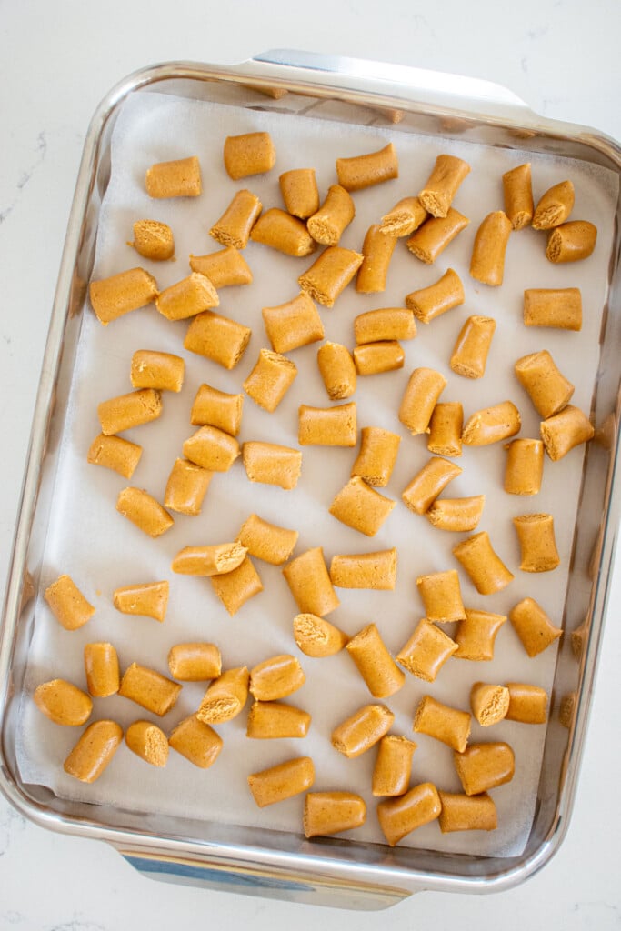 mini peanut butter oat dog treats on a sheet pan.