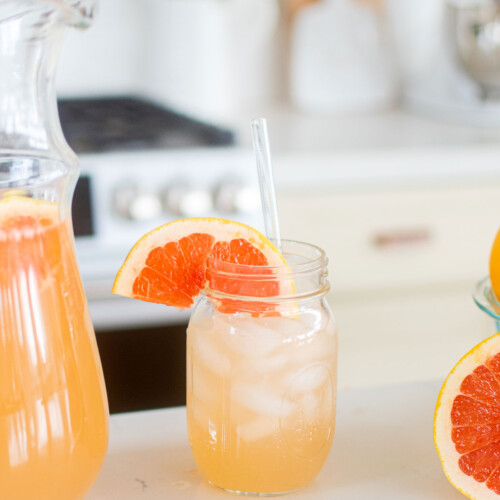 organic pink grapefruit juice in a glass on the kitchen countertop.