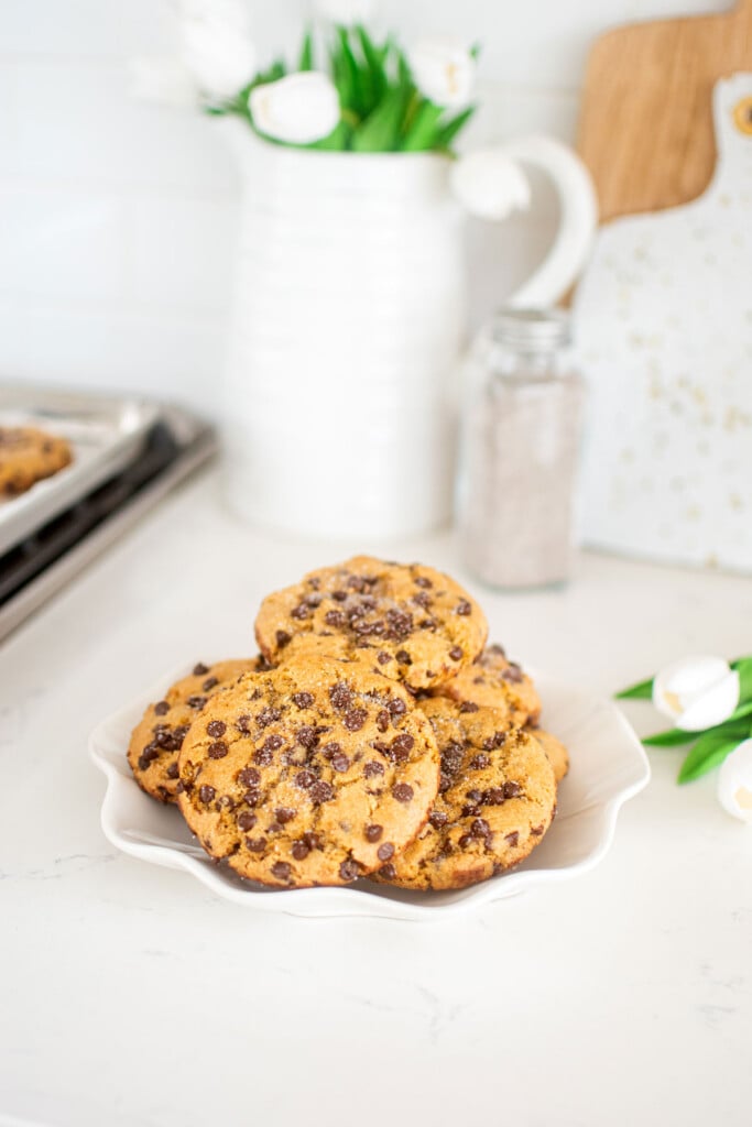 plate of vanilla sea salt chocolate chip cookies on a white marble kitchen counter.
