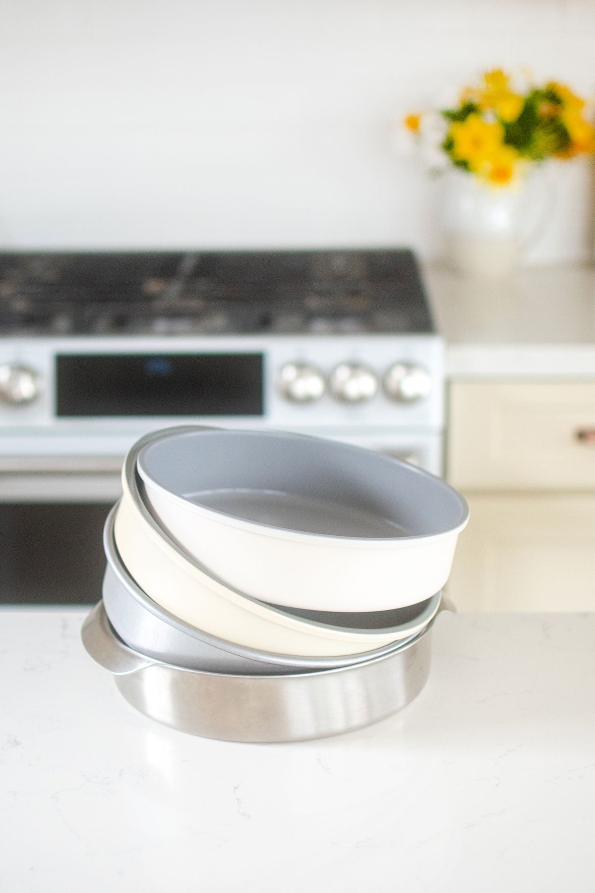 nontoxic cake pans in a stack on the kitchen counter.