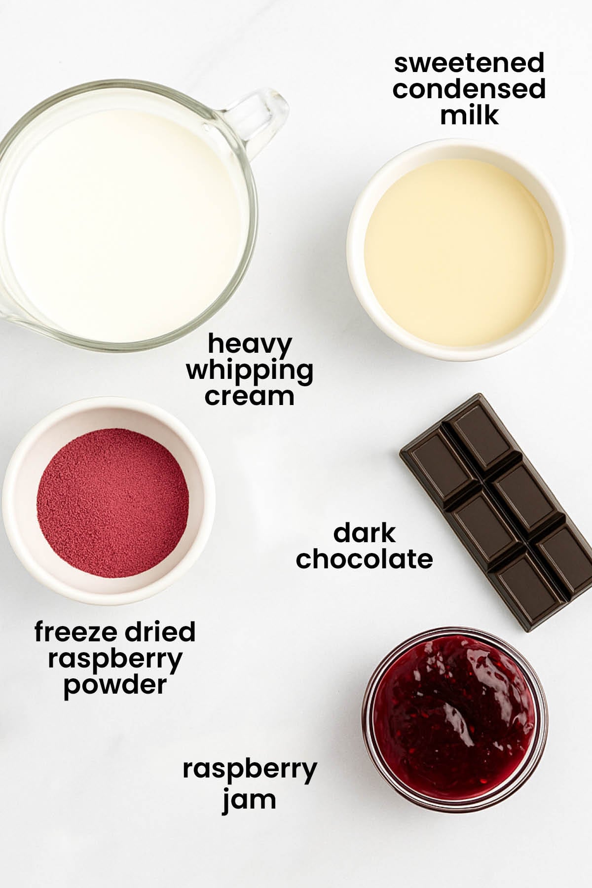 individual ingredients for raspberry chocolate chip ice cream laid out against a white background.