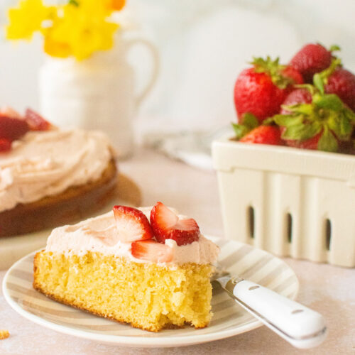 strawberry buttercream frosting on a vanilla cake slice