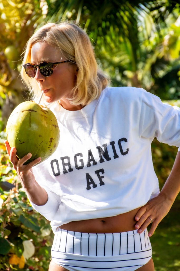 woman drinking out of a coconut