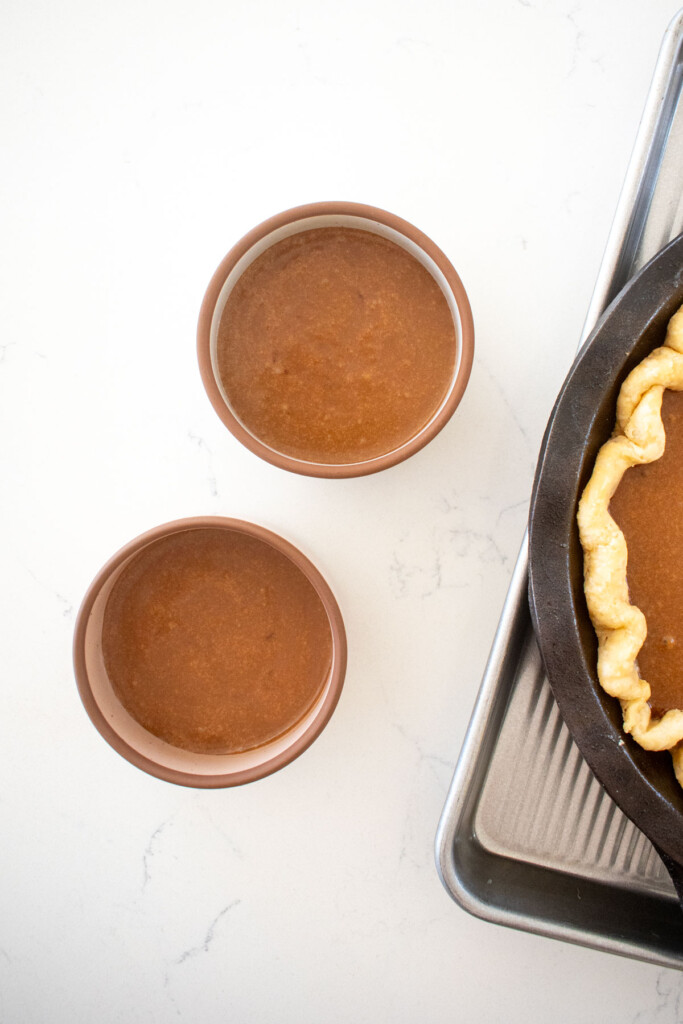 chocolate pumpkin pie in small ramekins on a white marble counter.