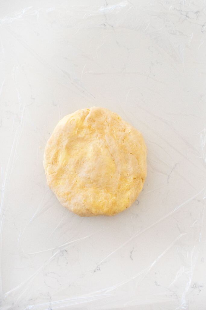 pie dough on a white marble counter.