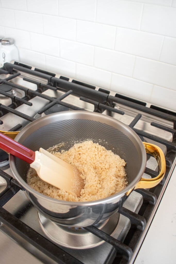 cane sugar melting in a a titanium pot on the stovetop.