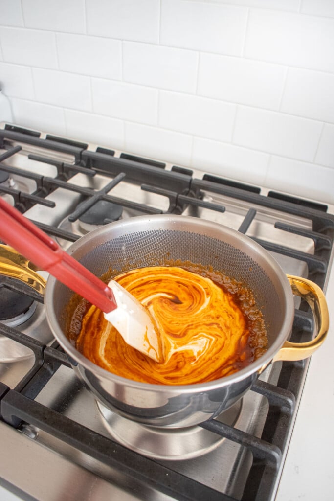 gingerbread caramel sauce being made in a titanium pot on the stovetop.