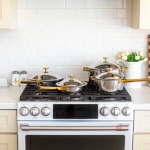 our place titanium pan set on top of a white range.