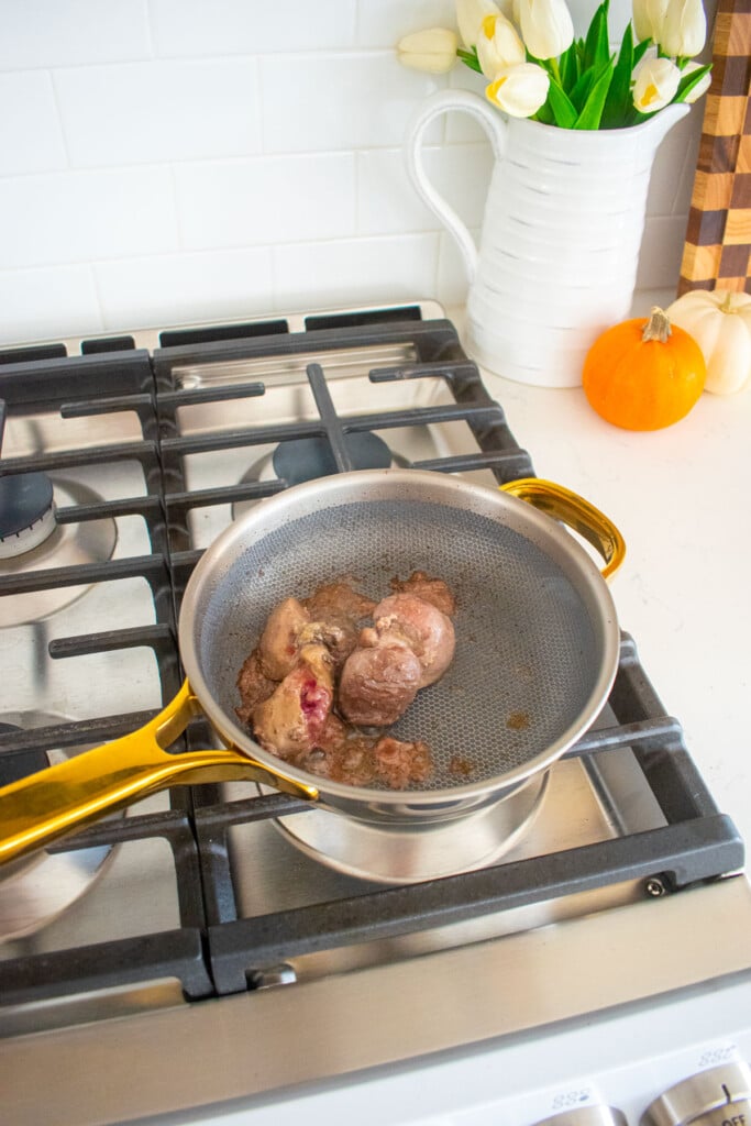 cooked turkey giblets in a skillet on the stovetop.