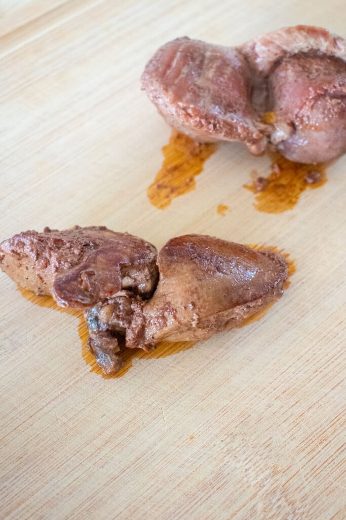 cooked turkey giblets on a cutting board.
