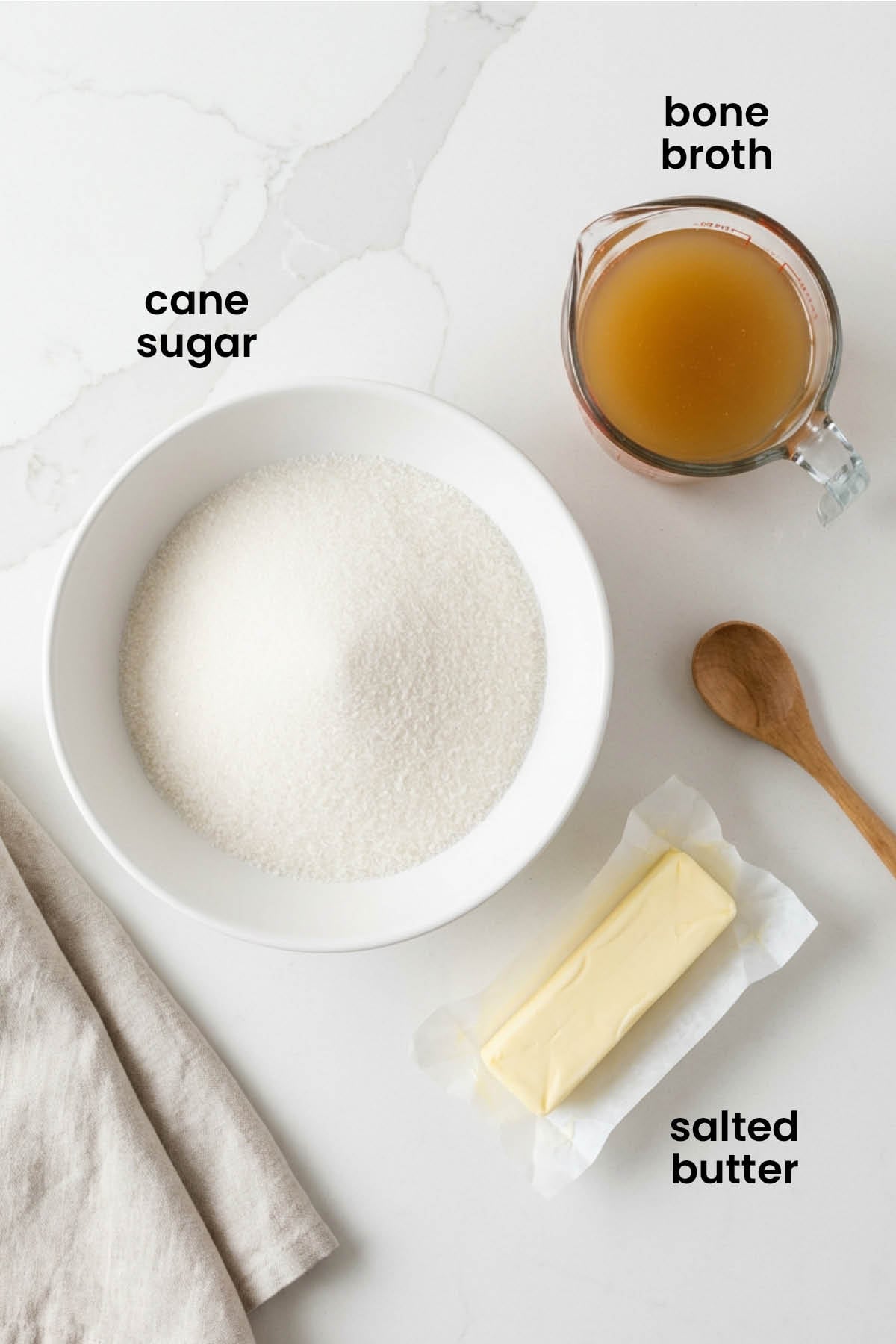 individual ingredients for homemade caramel sauce with bone broth laid out against a white background.