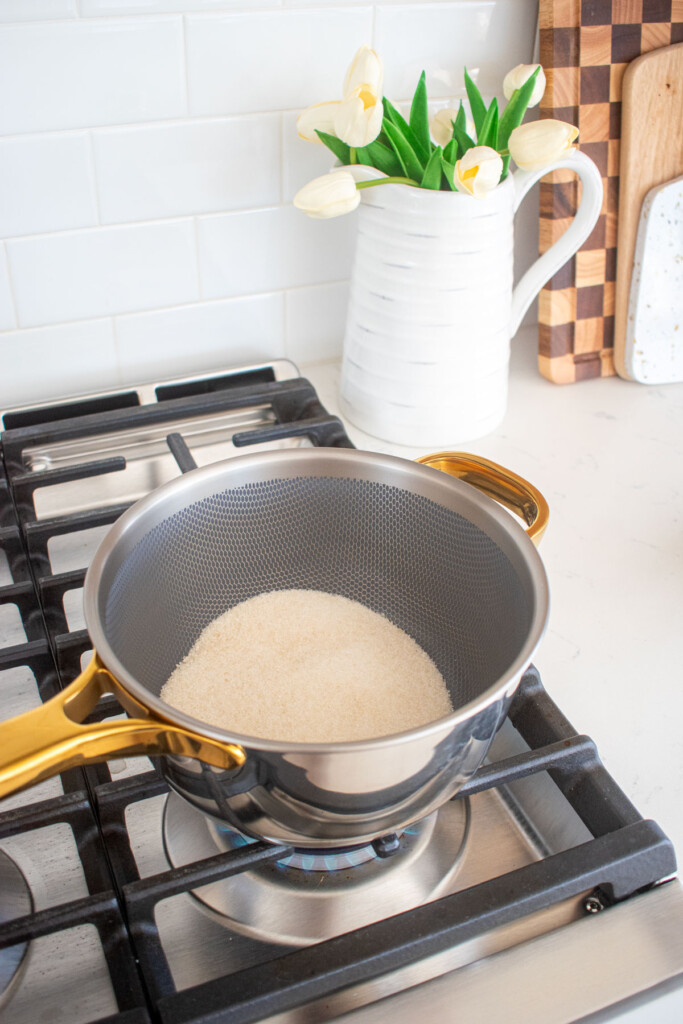 cane sugar in a titanium pot on the stovetop.